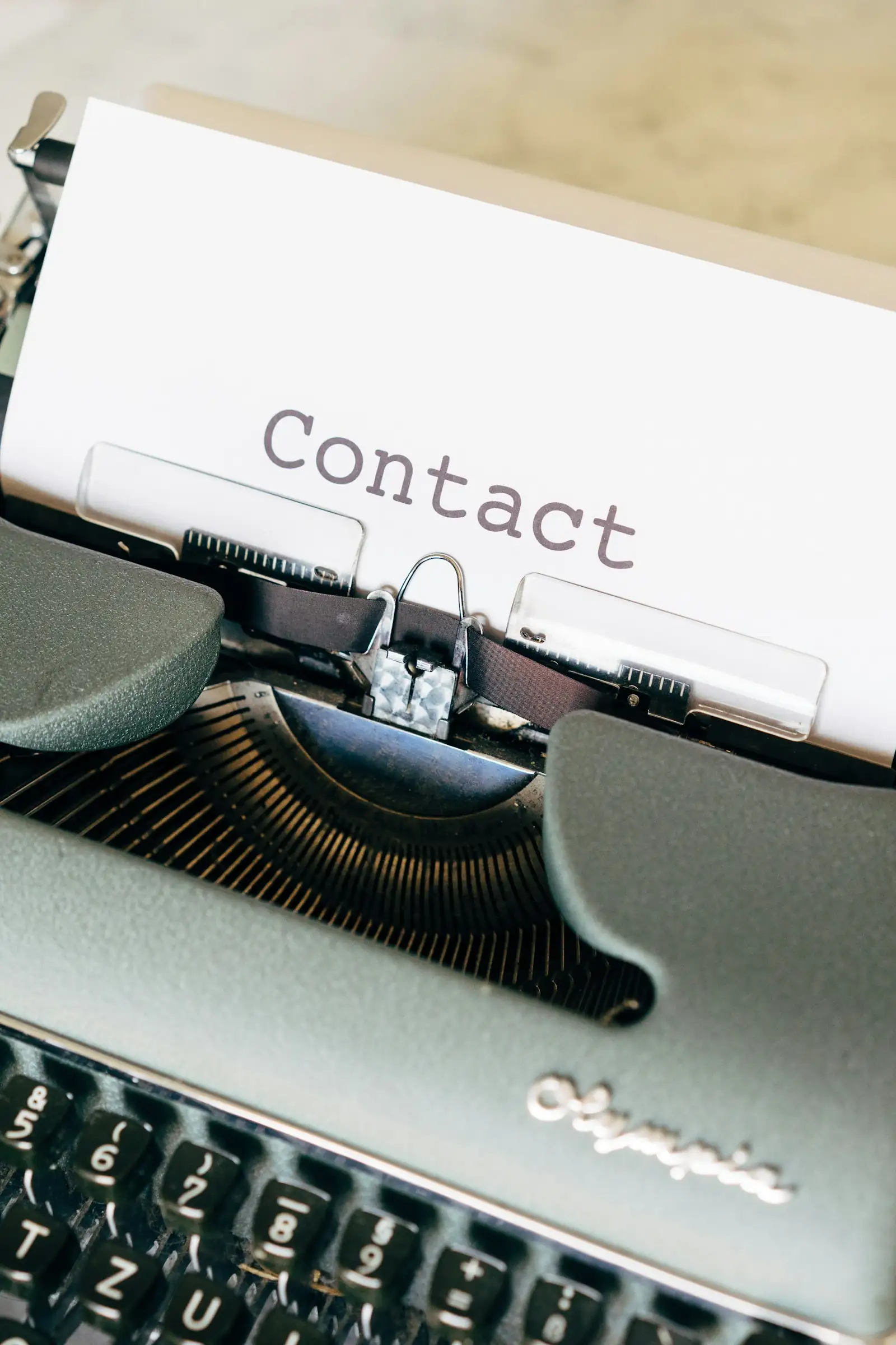 Typewriter with a “Contact” sheet