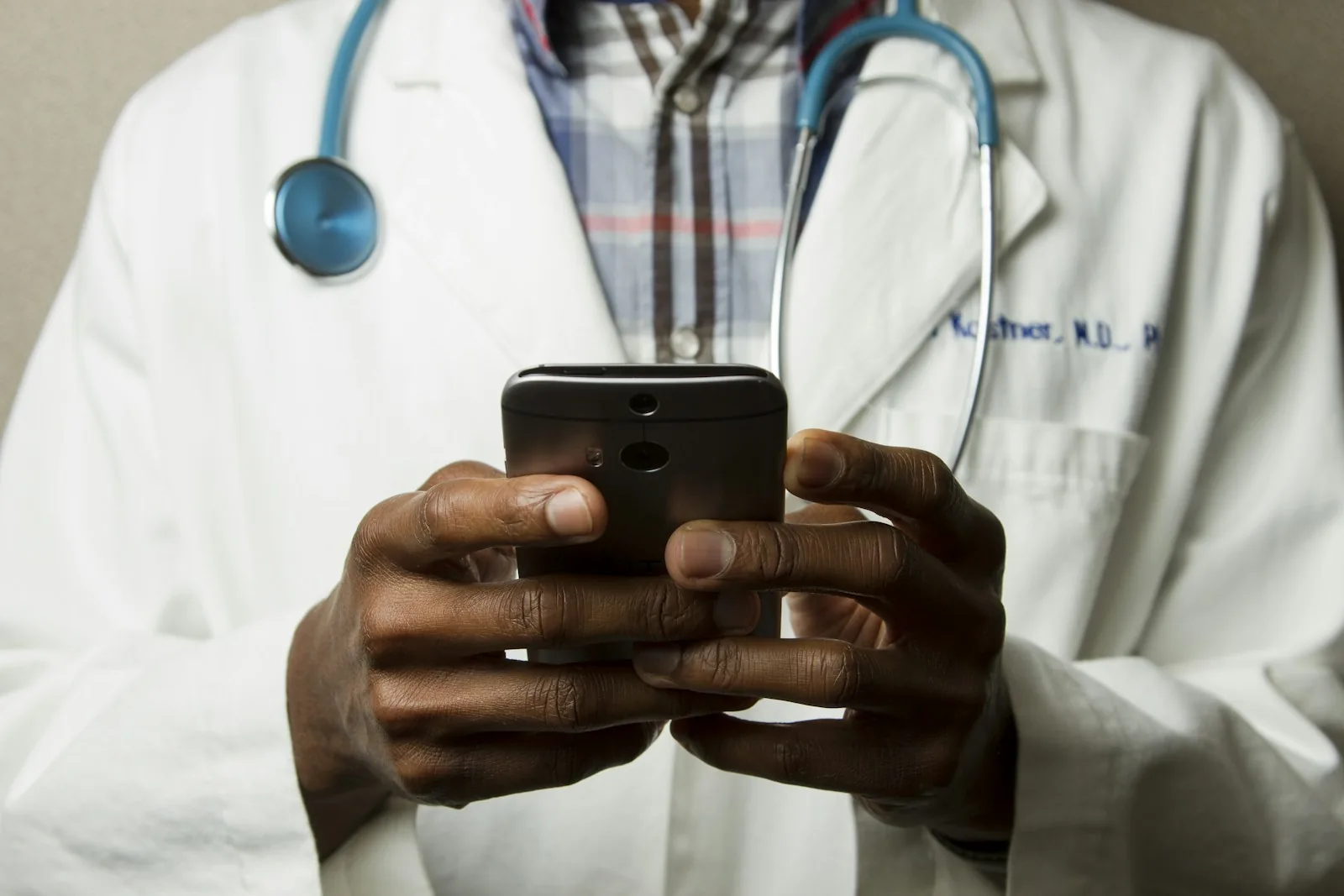 Doctor checking messages on a phone
