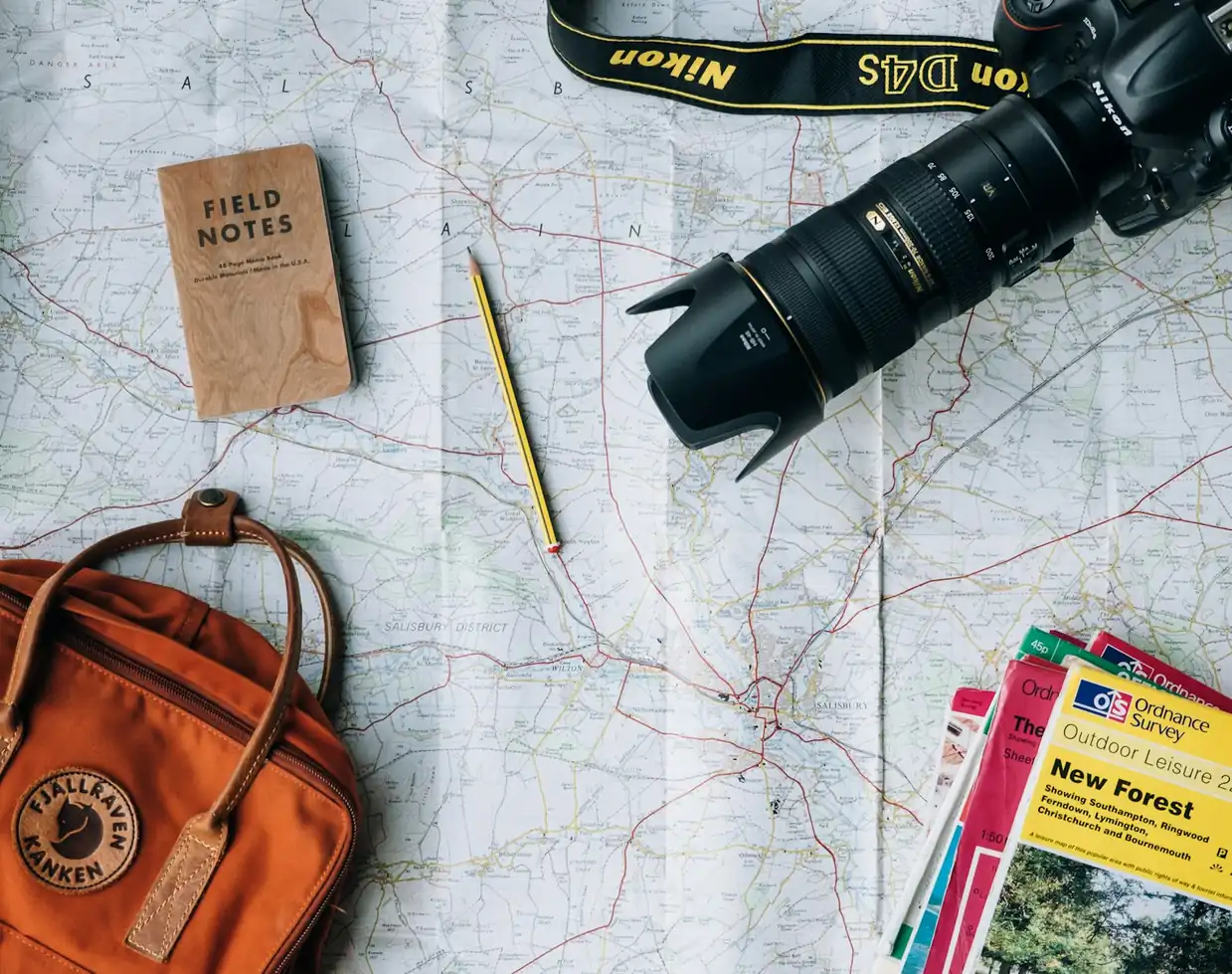 Map, camera and travel gear laid out for trip planning