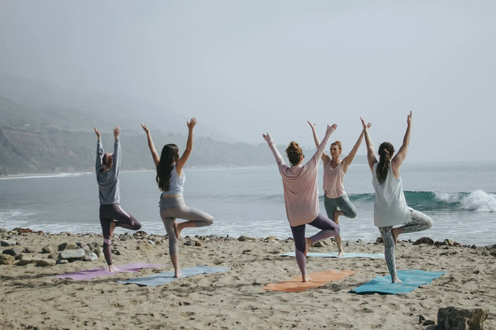 Group yoga class on a beach
